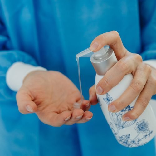 Detailed image of hands applying hand sanitizer, emphasizing hygiene and cleanliness.
